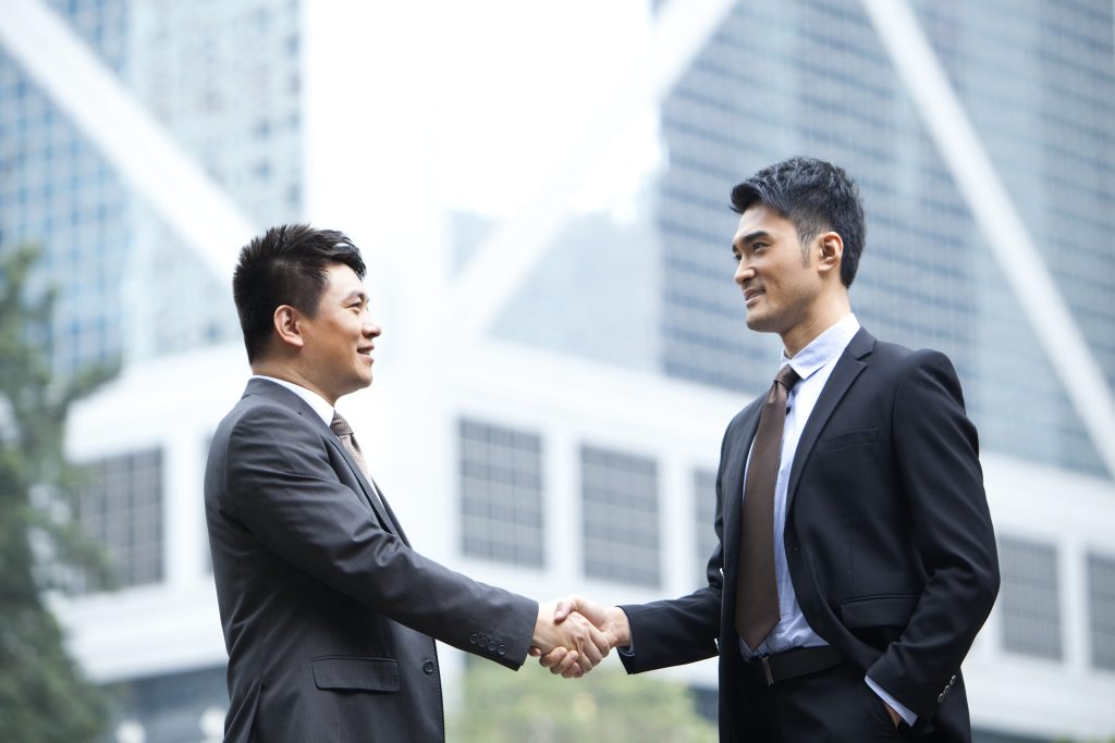 China business man shaking hand